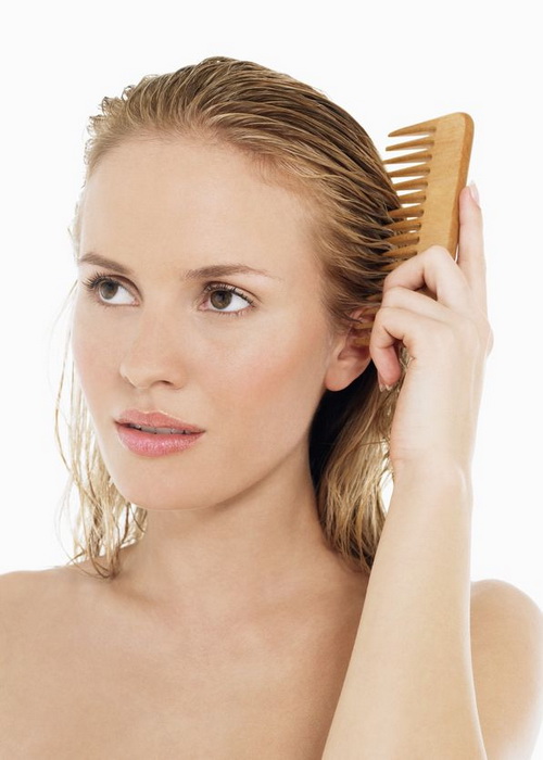 Young Blond Woman Combing Hair